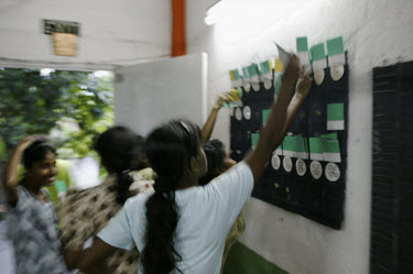 Female workers clocking off after a day's work at Marie De Classique garment factory.    This factory does not comply with Sri Lankan labour regulations.  Health and safety and conditions of work are...