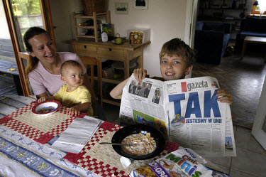 A family eating breakfast, reading newspaper reports of the yes vote in the referendum on accession to the European Union (EU). The headline reads "Yes, we are in the union." Around three quarters of...