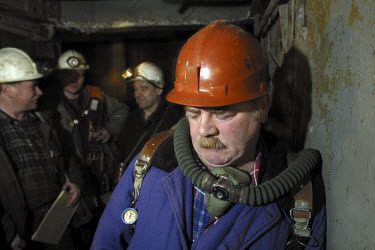 Miners descend in a lift shaft to the Taimyrsky nickel ore mine. Many people migrate to this resource-rich Siberian city above the Arctic Circle for work. Jobs with the Norilsk Nickel company pay some...
