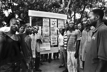 A standing parliament - a newsstand where people read and talk about politics. Different newsstands attract the supporters of particular political parties. This, the standing parliament of Elf-Lusaka,...