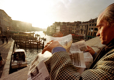 Franco Moretti reads his afternoon paper at the Rialto Bridge during a break in his work. Franco is an administrative worker.