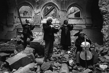 Orchestra playing in the ruins of a building destroyed in the war.