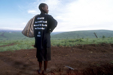 Rwandan boy in Benako refugee camp with a UNHCR T-shirt asking "What if the world had turned its back on Einstein?"