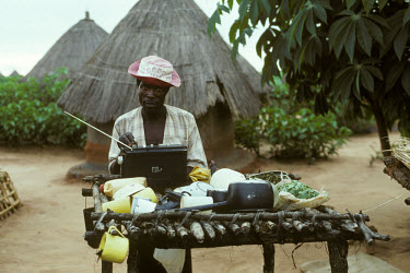 Worker on commercial farm with battery-powered radio.