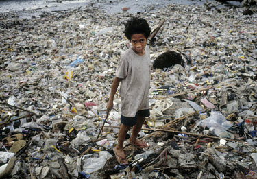 Boy from a homeless family makes money recycling plastic from the beach.
