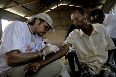 Medecins Sans Frontieres (MSF) doctor taking blood at remote rural clinic, in an attempt to identify a virus which had killed 200 people.