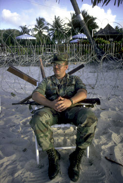 An American soldier on guard outside army HQ following the US invasion of the island after the collapse of the revolutionary government of Maurice Bishop.