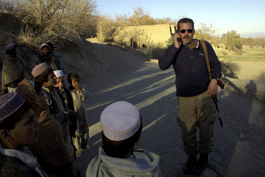 Jonathan K Idema, known as 'Jack', on the road from Kabul to Jalalabad. Idema, an American mercenary, was organising protected convoys between the two cities after a spate of robberies and murders. In...