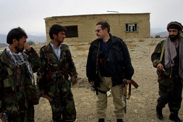 Jonathan K Idema, known as 'Jack', on the road from Kabul to Jalalabad with local gunmen. Idema, an American mercenary, was organising protected convoys between the two cities after a spate of robberi...