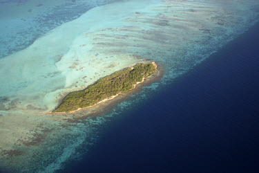 Aerial view of a small Caribbean island with a coral reef.