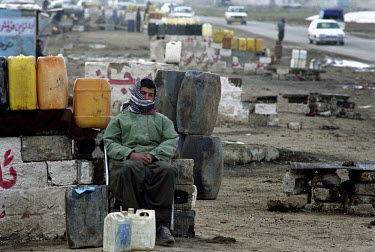 Kurdish petrol smuggler selling fuel at the side of the road.