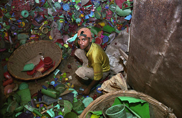 Boy recycling plastic.