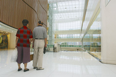 An old couple explore a new shopping complex in Shanghai.