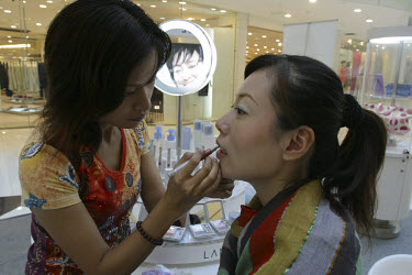 Getting made up in a department store.