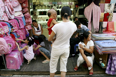 Families shopping at a market selling counterfeit goods.