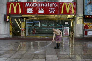 Cleaning the pavement outside McDonald's.
