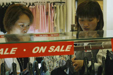Women buying clothes in a sale.