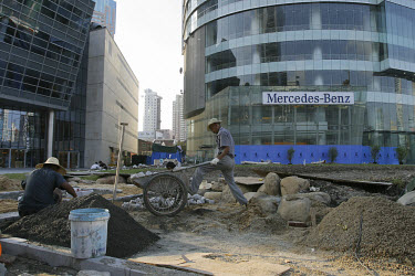 Building labourers working outside Mercedes-Benz building.
