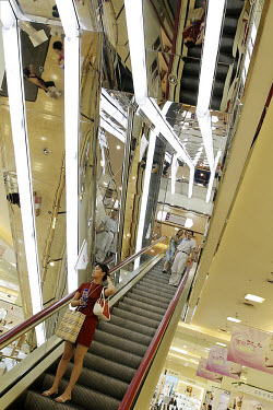 A girl on an escalator in a department store.