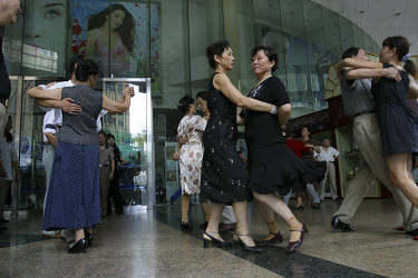 People dancing in front of department store.