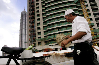 Man selling food in the Pudong district.
