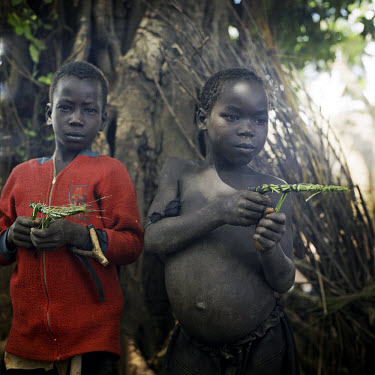Boys playing with toy guns made of grass. Many children of their age have been forced to fight for real after being abducted by the Lord's Resistance Army (LRA).