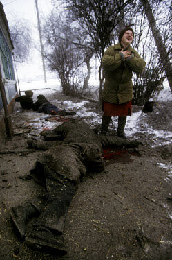 A woman grieves for ethnic Russian friends and neighbours who were mowed down by artillery attack. They had been standing in line at what they had heard was a distribution point for bread. Many Russia...