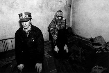 A Chechen man and woman pray in a local military headquarters in rural Chechnya.