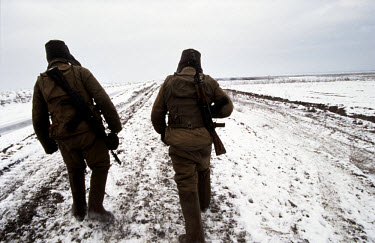 Russian soldiers at the edge of a village.