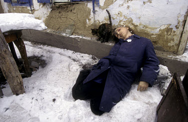 A resident of Grozny lies dead outside his home, a victim of the Russian air and artillery assault on the city.