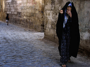 Veiled woman. Sanliurfa is one of the oldest cities in Turkey, known as Ur in ancient times. It is now a mixed Arab, Turkish and Kurdish town. Christian pilgrims still visit a cave nearby which is sai...