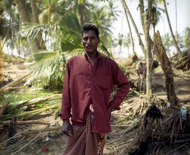 A man stands in the wreckage of his village, destroyed by the tsunami which struck South Asia on 26/12/2004. An underwater earthquake measuring 9 on the Richter scale triggered a series of tidal waves...