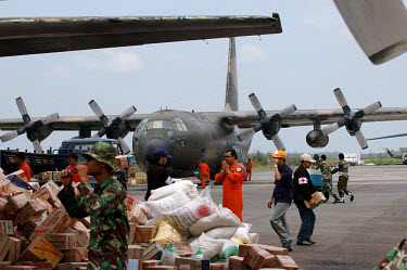 Indonesian and foreign military aircraft fly humanitarian aid into the small airport at Banda Aceh. Shipments of food, water, shelter and medicines were desperately needed following the tsunami which...