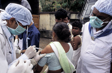 Doctors administering vaccinations to prevent the spread of disease amongst victims of the tsunami which struck South Asia on 26/12/2004. An underwater earthquake measuring 9 on the Richter scale trig...