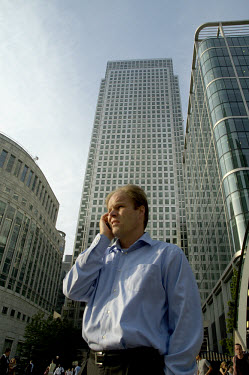 Businessman using his mobile telephone on Jubilee Place in Canary Wharf, the centrepiece of the redeveloped Docklands.