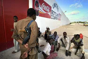 Gunmen outside the recently opened Coca Cola bottling plant in Mogadishu. As with all businesses in Somalia, the premises are heavily guarded by armed militias to prevent looting. Business is flourish...