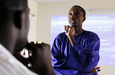 A lecturer delivers an economics lecture in English at Suffolk University's satellite campus in Dakar. Suffolk University, a private American college, opened the campus in 1999, aiming to attract midd...