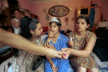 Ingrid Zigova, a Roma gypsy bride (centre), gets a little help from relatives during preparations for her wedding.