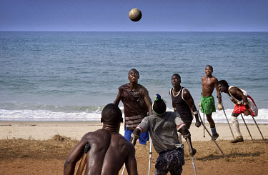 The Single Leg Amputee Sports Club play football on the beach.