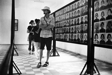 Tourists at Tuol Sleng museum, formerly the S-21 Khmer Rouge detention centre, where over 16,000 inmates were killed between 1975 and 1979. The Khmer photographed every prisoner before they were kille...