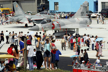 Spectators look at Mirage and F-16 aircraft at an air show at a military base near Taipei.