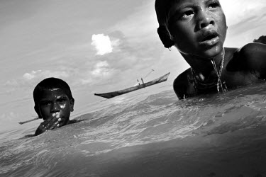 Moken children swimming. The Moken are a nomadic tribe of sea gypsies, numbering some two hundred, who live on Mu Ko Surin island off the western coast of Thailand. Scientific studies have shown that...