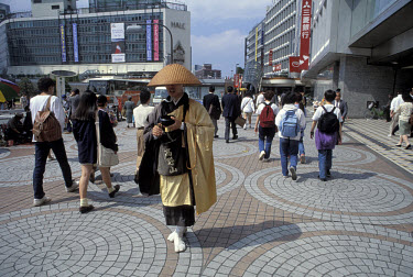 Zen Buddhist monk asking for alms from passers-by in the busy Shinjuku district.