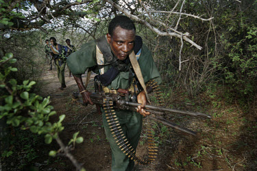 Oromo Liberation Front (OLF) fighters patrol an area of bush near the Kenyan border, in their 4th Military Zone. The area is dangerous and the fighters need to keep a look-out for both Ethiopian gover...