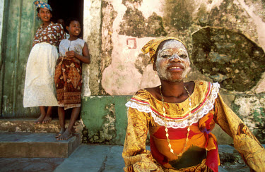 Atija, a young Macoa woman, her face covered with a paste made from a mixture of root and water.