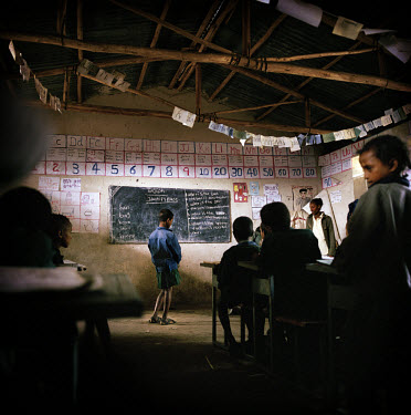 An English lesson in Chimbiri school. The signs on the wall are inspired by teaching methods introduced by Voluntary Service Overseas (VSO) volunteers. The same teacher teaches both the morning and af...