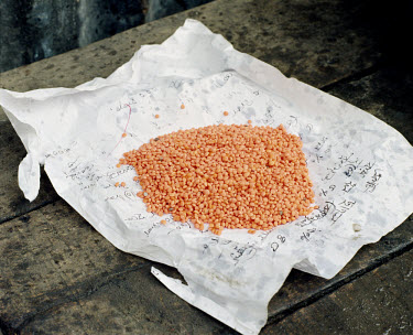 A handful of lentils, enough to feed a family for one evening.  Some items are bought on credit, with promises to repay the shopkeeper later.