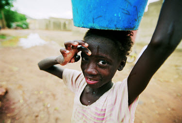 A young girl carrying water. Until recently people here have depended on water from traditional wells which were drying out.