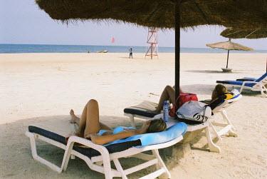 Lone women are a familiar sight on the beaches here. The 'bumsters' will soon approach and try to sell their wares - and sometimes themselves. Many young Gambian men earn a living by selling sex to fe...