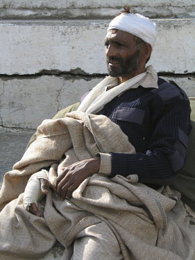 An injured survivor of the earthquake which struck Pakistani-administered Kashmir on 08/10/2005 awaiting medical evacuation at a helipad. At least 40,000 people were killed by the 7.6 magnitude earthq...